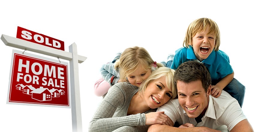 dad next to a mom with two kids on their backs next to a home for sale sign that says sold on top
